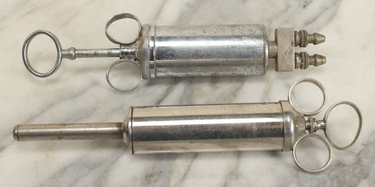 Lot 038 - Pair Of Antique Metal Syringes Including Empire By Becton, Dickinson, & Co., Rutherford, New Jersey