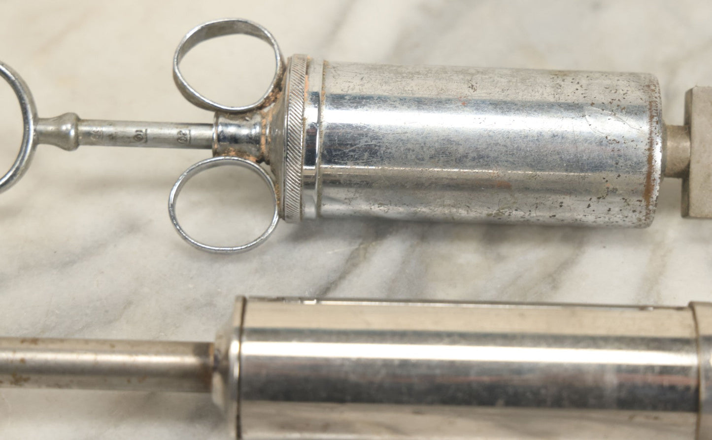 Lot 038 - Pair Of Antique Metal Syringes Including Empire By Becton, Dickinson, & Co., Rutherford, New Jersey