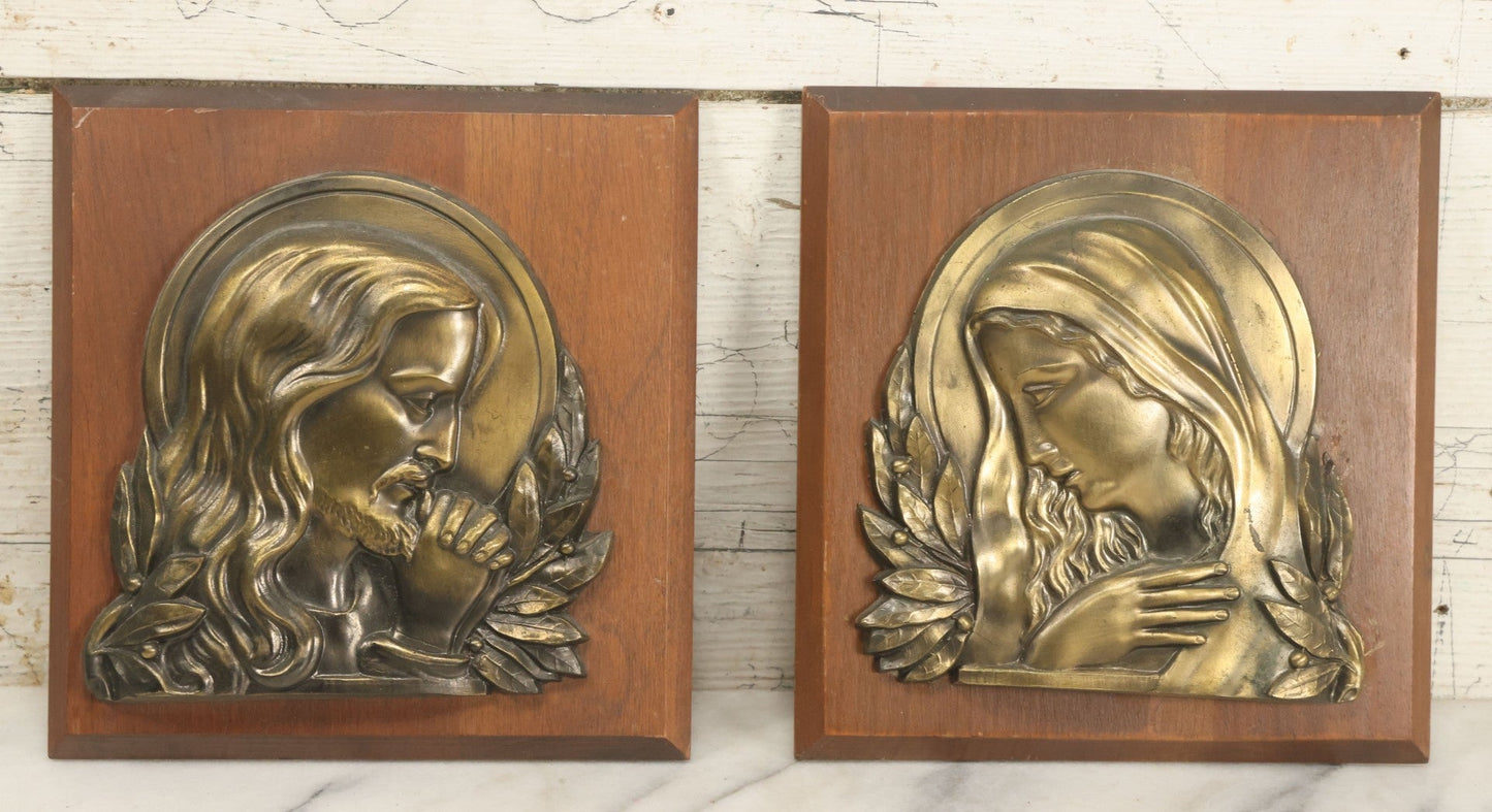 Lot 068 - Pair Of Cast Metal Religious Decor Plaques With Jesus Christ And The Virgin Mary, Mounted To Wood Panel