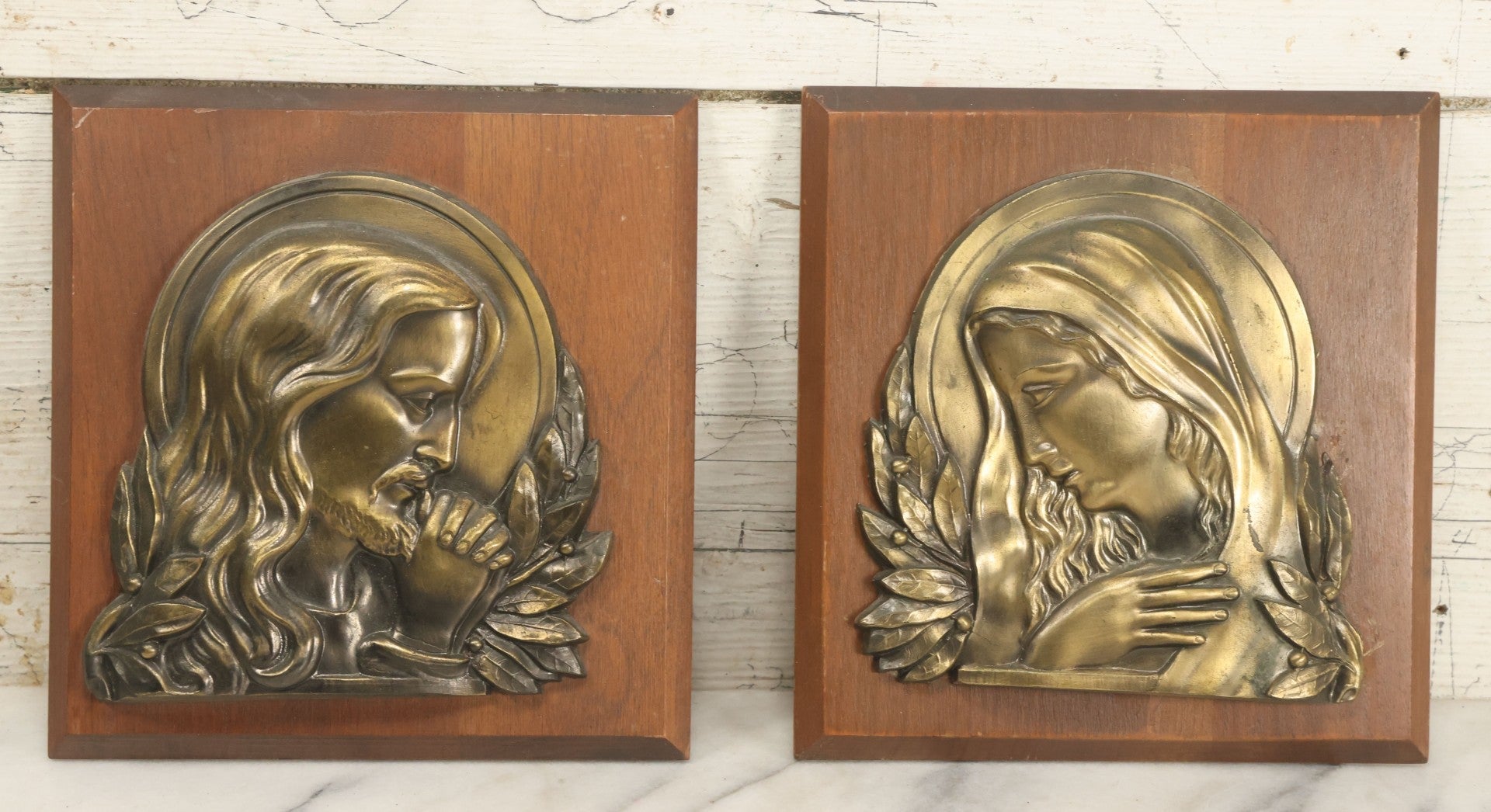 Lot 068 - Pair Of Cast Metal Religious Decor Plaques With Jesus Christ And The Virgin Mary, Mounted To Wood Panel