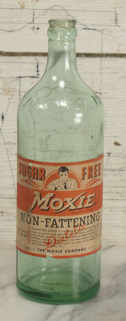Lot 129 - Vintage Sugar Free Moxie Non-Fattening Dietic Tonic Soda Bottle With Original Paper Label, Bottled By The Moxie Company, Needham Heights, Massachusetts