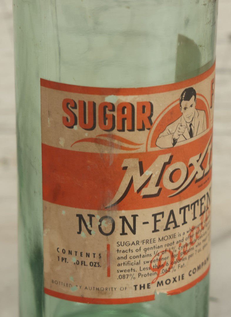 Lot 129 - Vintage Sugar Free Moxie Non-Fattening Dietic Tonic Soda Bottle With Original Paper Label, Bottled By The Moxie Company, Needham Heights, Massachusetts