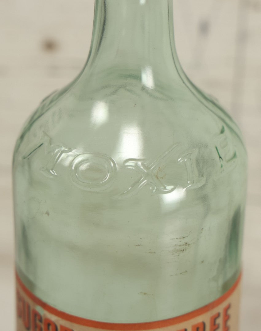 Lot 129 - Vintage Sugar Free Moxie Non-Fattening Dietic Tonic Soda Bottle With Original Paper Label, Bottled By The Moxie Company, Needham Heights, Massachusetts