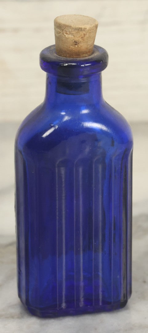 Lot 005 - Pair Of Antique Cobalt Blue Glass Pharmacy Bottles, Including Poison Bottle With Partial Paper Label, And Camphoric Acid Bottle