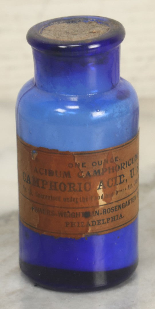Lot 005 - Pair Of Antique Cobalt Blue Glass Pharmacy Bottles, Including Poison Bottle With Partial Paper Label, And Camphoric Acid Bottle