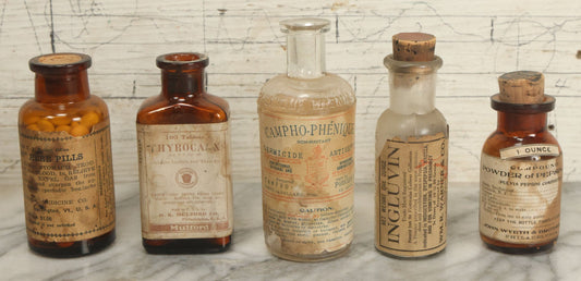 Lot 006 - Grouping Of Five Antique And Vintage Pharmacy Bottles With Paper Labels, Including "Solon" Herb Pills, Ingluvin Bottle, Powder Of Pepsin Bottle, And Campho-Phenique Bottle