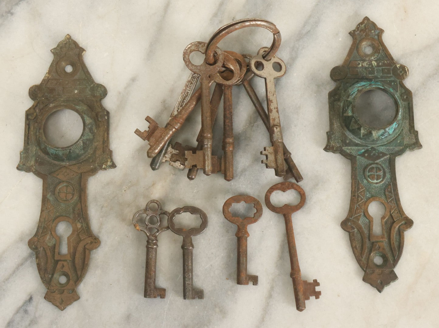 Lot 021 - Grouping Of Ten Antique Skeleton Keys And Two Ornate Antique Doorknob Mount Escutcheons, As Found