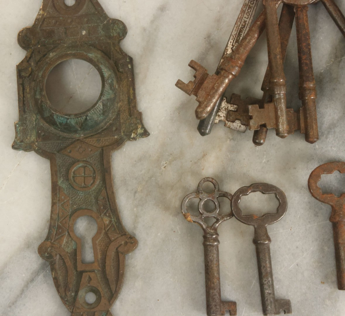 Lot 021 - Grouping Of Ten Antique Skeleton Keys And Two Ornate Antique Doorknob Mount Escutcheons, As Found