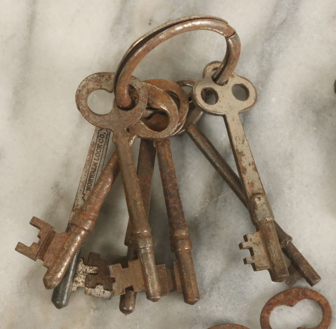 Lot 021 - Grouping Of Ten Antique Skeleton Keys And Two Ornate Antique Doorknob Mount Escutcheons, As Found