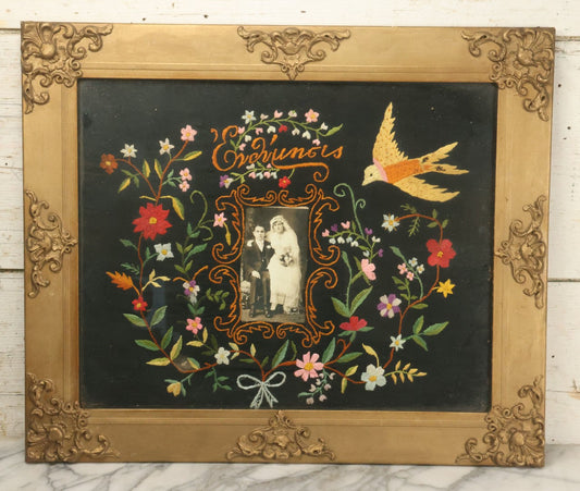 Lot 027 - Antique Folk Art Marriage Commemoration Floral Embroidery With Bird And Photograph Of Married Couple At Center, In Frame