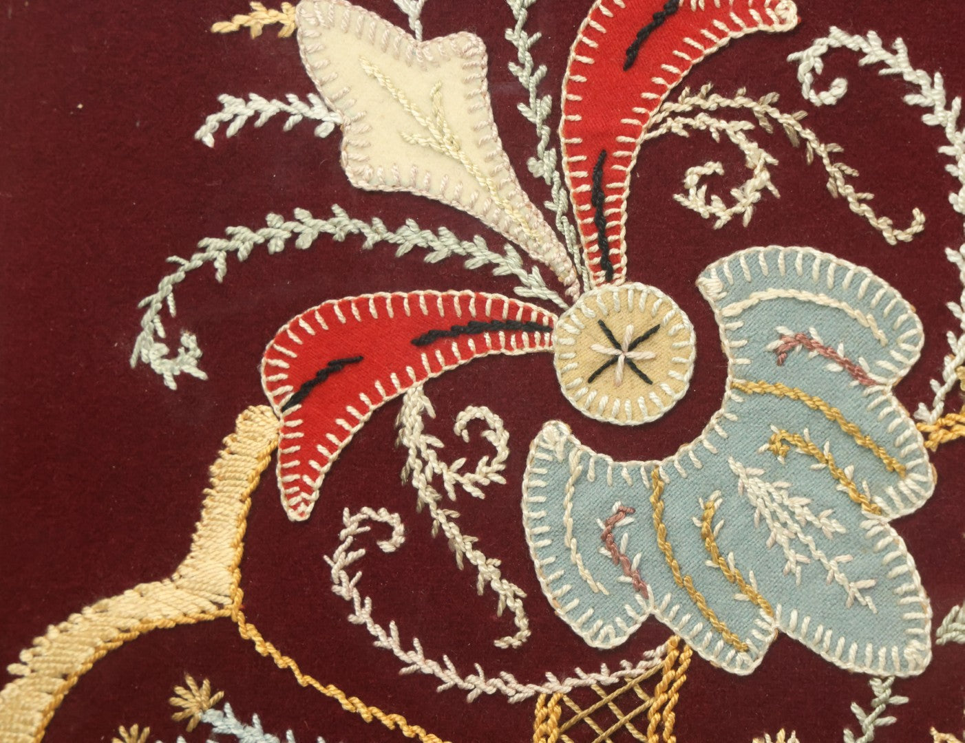 Lot 028 - Vintage Folk Art Needlepoint Embroidery Medallion With Blue, Red, And Yellow Thread On Maroon Field, In Frame