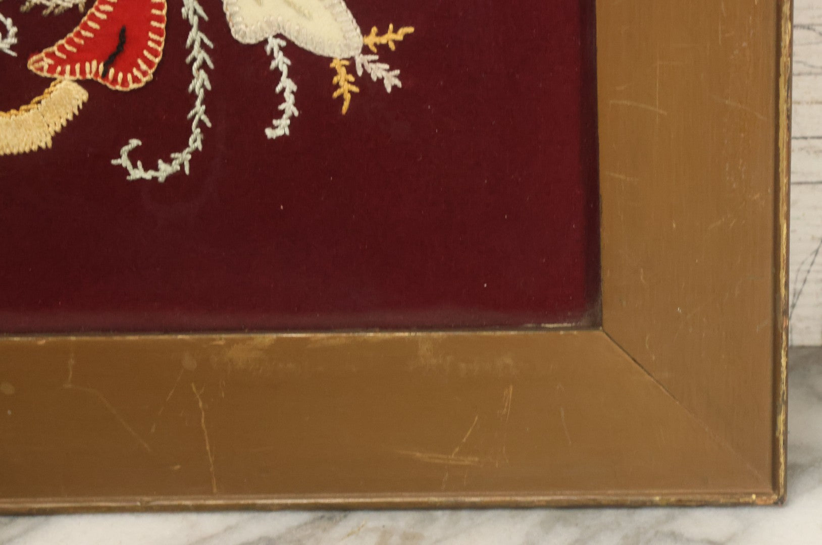 Lot 028 - Vintage Folk Art Needlepoint Embroidery Medallion With Blue, Red, And Yellow Thread On Maroon Field, In Frame