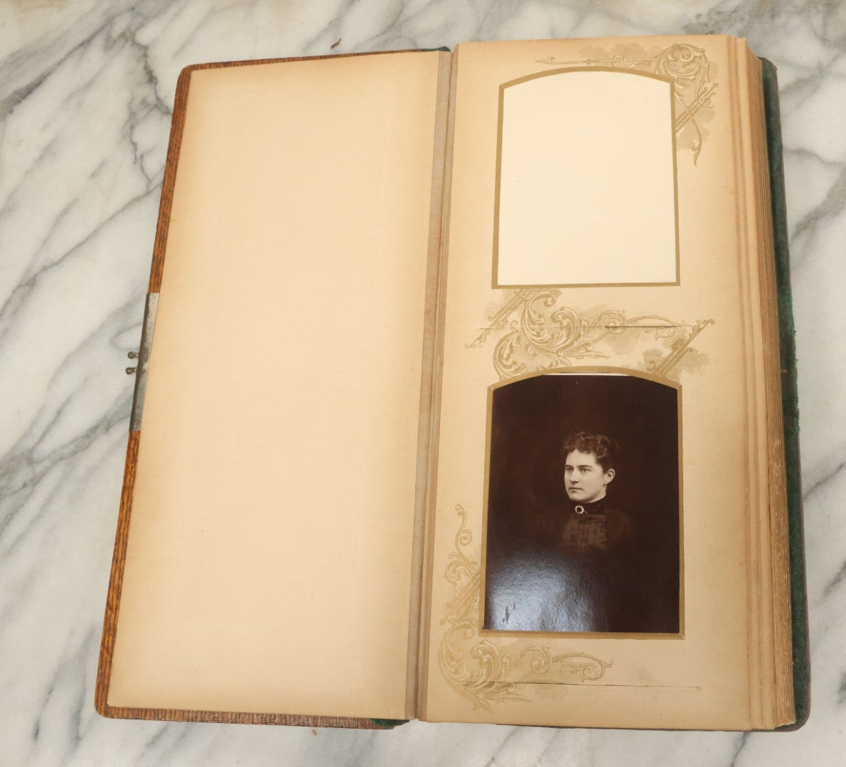 Lot 034 - Antique Victorian Cabinet Card Photo Album With Thirteen Cabinet Card Photographs And Laquered Wooden Cover With Metal Album Adornment And Green Fabric Back, Note Latch Missing