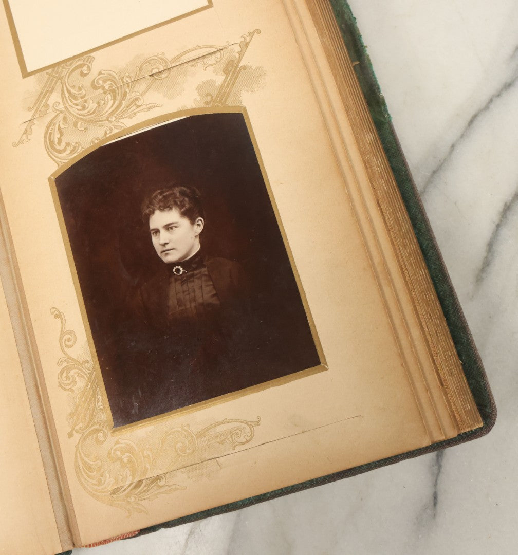 Lot 034 - Antique Victorian Cabinet Card Photo Album With Thirteen Cabinet Card Photographs And Laquered Wooden Cover With Metal Album Adornment And Green Fabric Back, Note Latch Missing