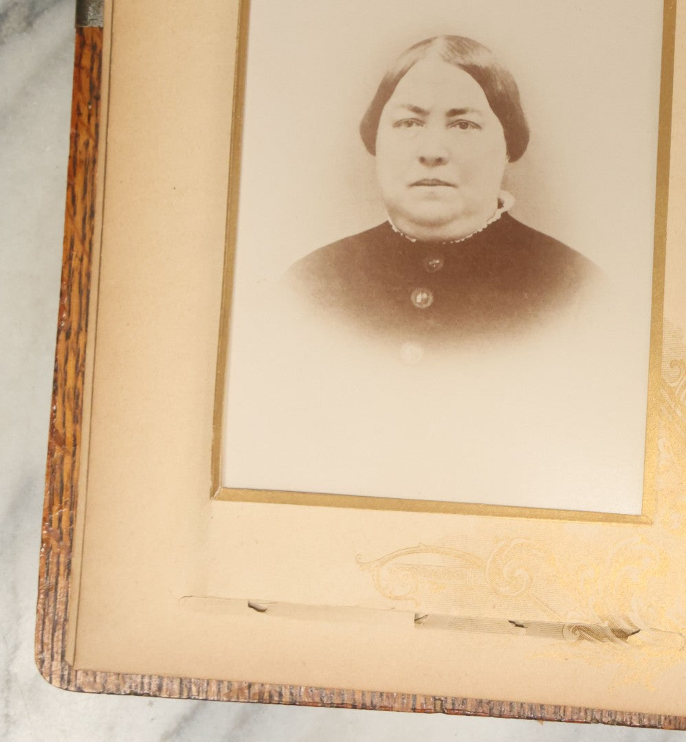 Lot 034 - Antique Victorian Cabinet Card Photo Album With Thirteen Cabinet Card Photographs And Laquered Wooden Cover With Metal Album Adornment And Green Fabric Back, Note Latch Missing