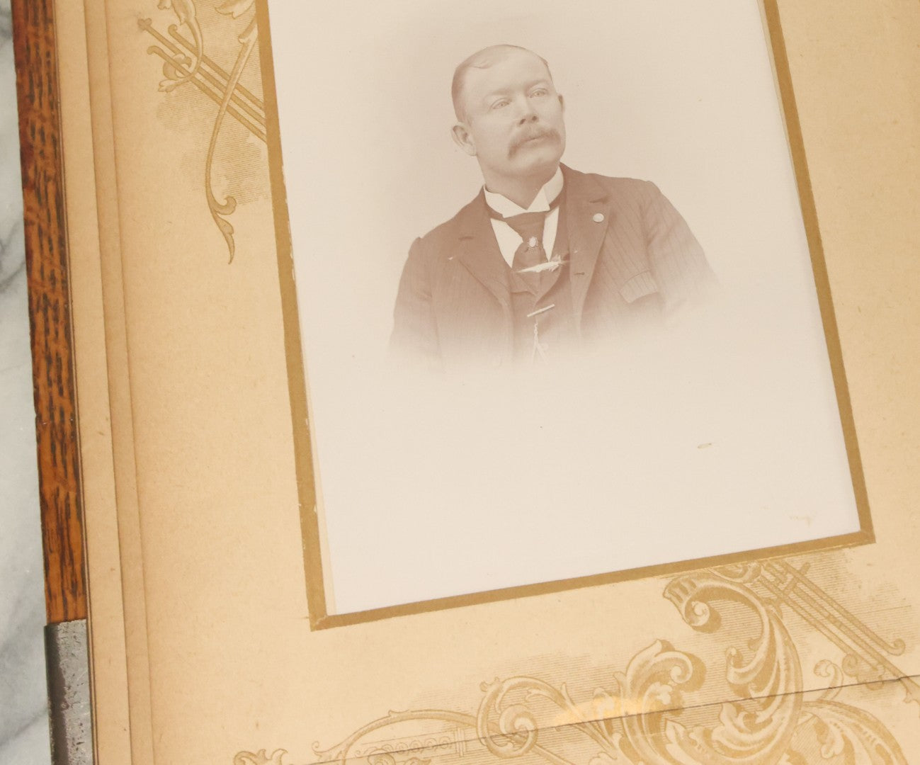 Lot 034 - Antique Victorian Cabinet Card Photo Album With Thirteen Cabinet Card Photographs And Laquered Wooden Cover With Metal Album Adornment And Green Fabric Back, Note Latch Missing