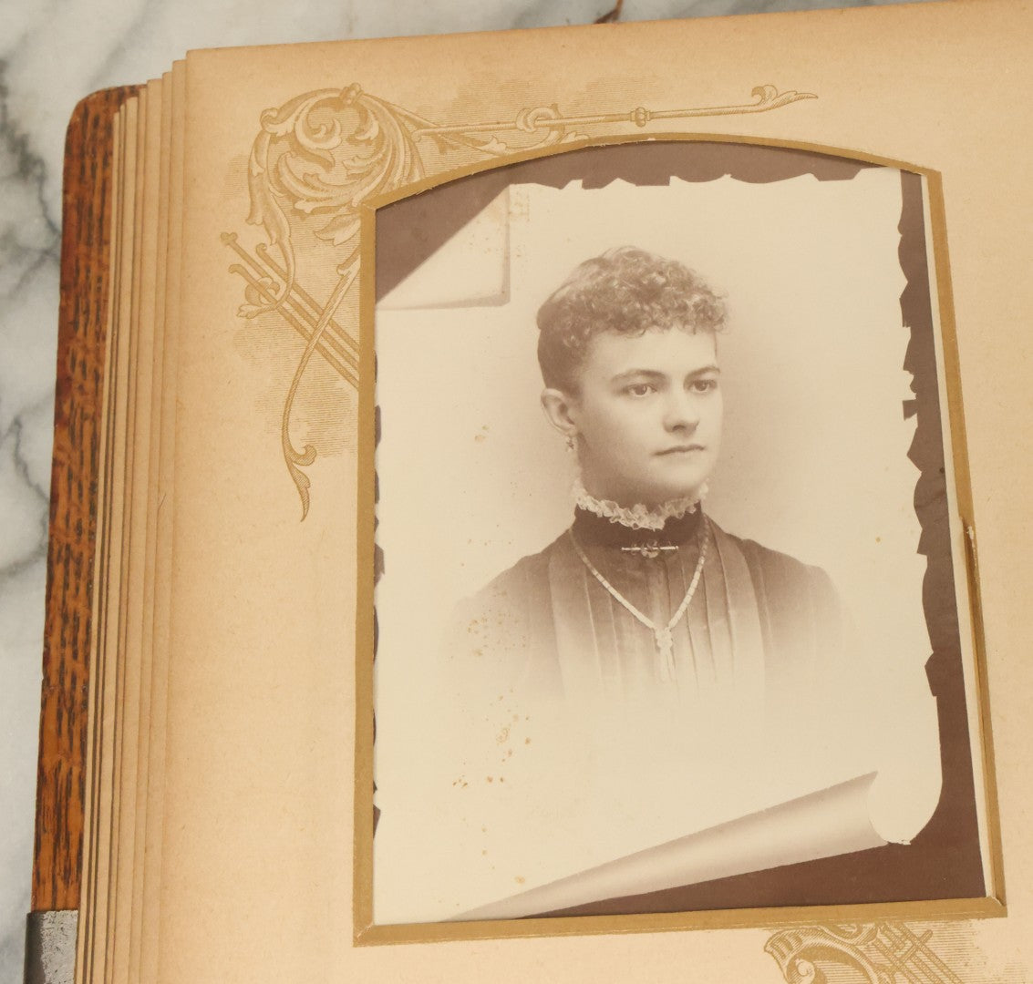 Lot 034 - Antique Victorian Cabinet Card Photo Album With Thirteen Cabinet Card Photographs And Laquered Wooden Cover With Metal Album Adornment And Green Fabric Back, Note Latch Missing