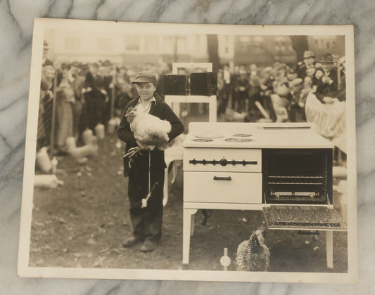 Lot 038 - Vintage Large Format Photograph Of Smiling Child Holding A Chicken At A Country Fair Beside An Oven