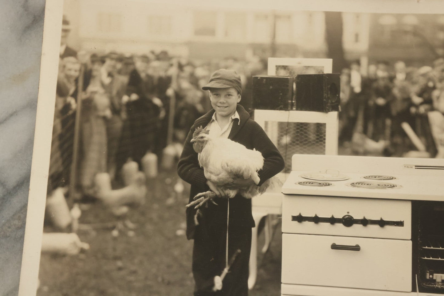 Lot 038 - Vintage Large Format Photograph Of Smiling Child Holding A Chicken At A Country Fair Beside An Oven