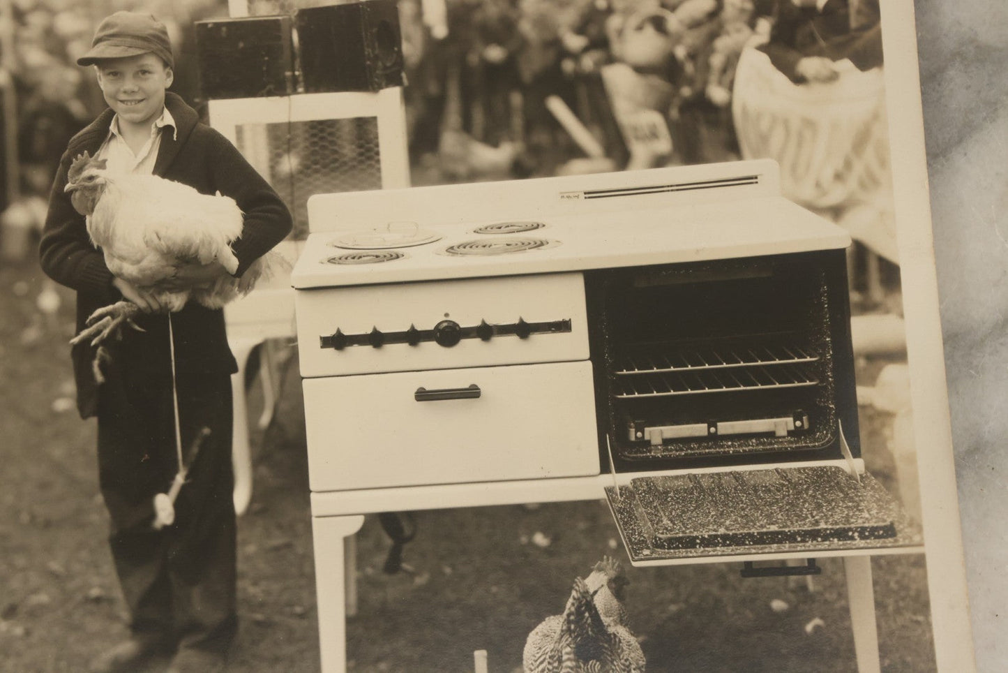 Lot 038 - Vintage Large Format Photograph Of Smiling Child Holding A Chicken At A Country Fair Beside An Oven