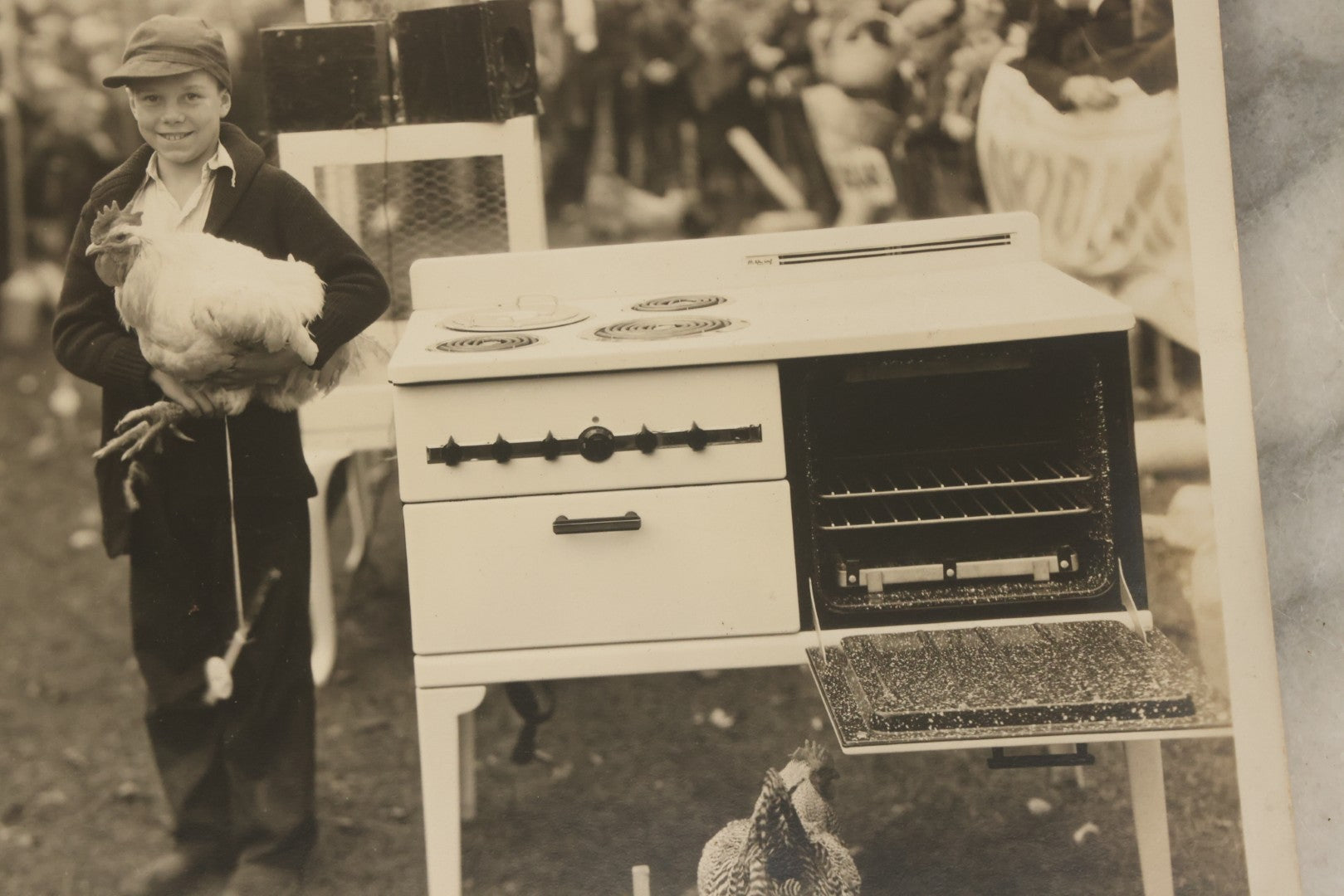 Lot 038 - Vintage Large Format Photograph Of Smiling Child Holding A Chicken At A Country Fair Beside An Oven