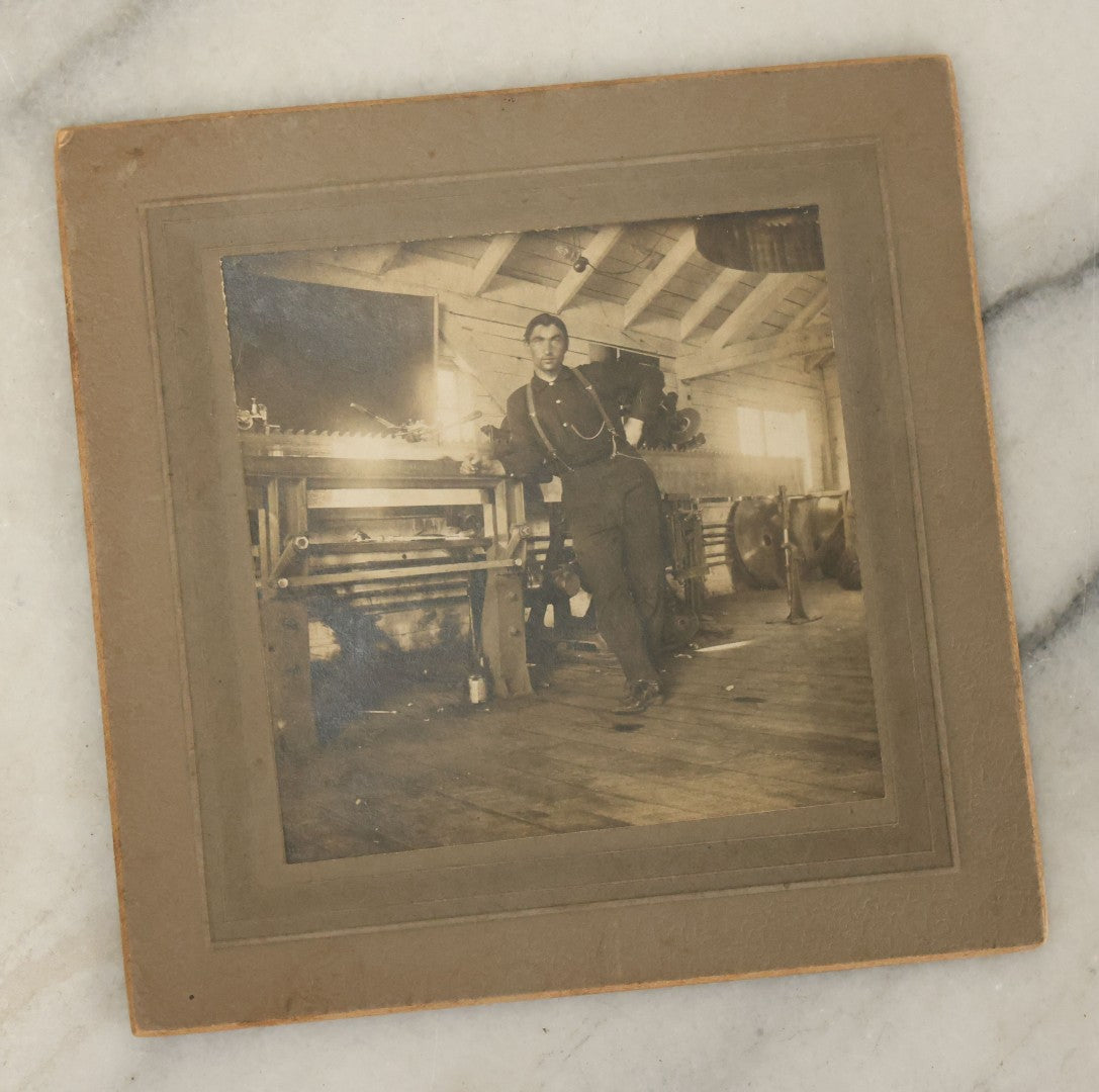 Lot 044 - Grouping Of Five Antique Boarded Photographs Including Worker Posing With Machinery, Exterior Of House, Women Standing By Tree, Horse-Drawn Carriage, And Baby