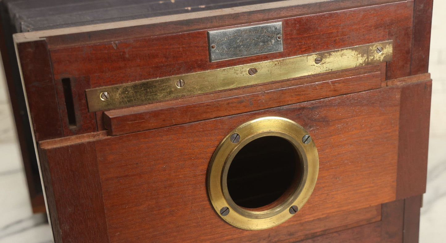 Lot 001 - Antique Wooden Camera By American Optical Company, Scovill Manufacturing Company, Proprietors, With New York, With Lens (Does Not Fit Camera) And Case From M.B. Loughman Photographic Apparatus, Boston - See Condition Notes