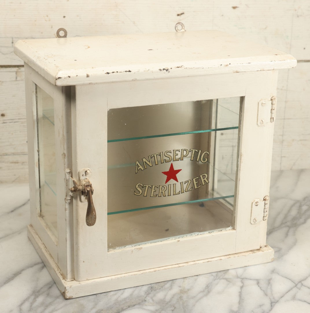 Lot 003 - Antique Wooden Barber Shop Antiseptic Sterilizer Cabinet With Glass Sides, Two Glass Shelves, And White Paint, Some Chipping To Shelves, Overall Dimensions Of Cabinet 13"L x 8-1/2"W x 12"H
