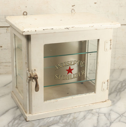 Lot 003 - Antique Wooden Barber Shop Antiseptic Sterilizer Cabinet With Glass Sides, Two Glass Shelves, And White Paint, Some Chipping To Shelves, Overall Dimensions Of Cabinet 13"L x 8-1/2"W x 12"H