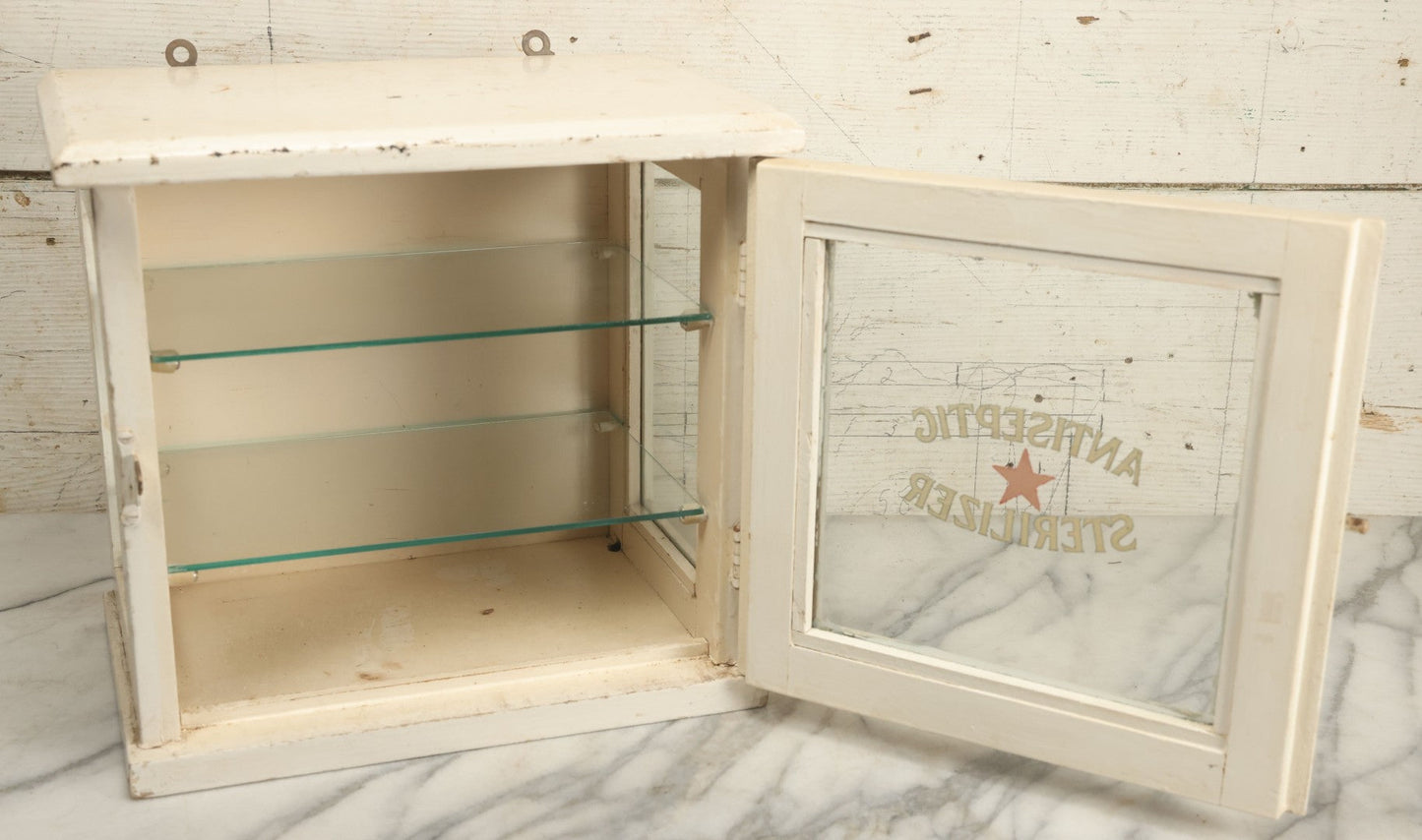 Lot 003 - Antique Wooden Barber Shop Antiseptic Sterilizer Cabinet With Glass Sides, Two Glass Shelves, And White Paint, Some Chipping To Shelves, Overall Dimensions Of Cabinet 13"L x 8-1/2"W x 12"H