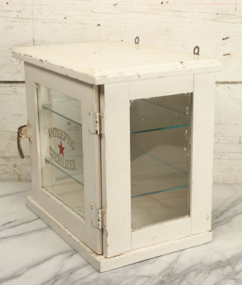 Lot 003 - Antique Wooden Barber Shop Antiseptic Sterilizer Cabinet With Glass Sides, Two Glass Shelves, And White Paint, Some Chipping To Shelves, Overall Dimensions Of Cabinet 13"L x 8-1/2"W x 12"H