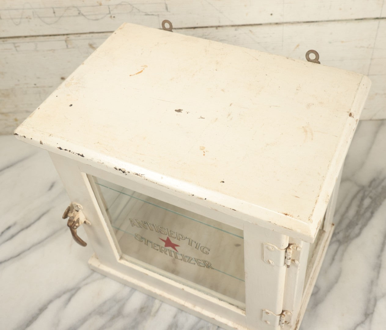 Lot 003 - Antique Wooden Barber Shop Antiseptic Sterilizer Cabinet With Glass Sides, Two Glass Shelves, And White Paint, Some Chipping To Shelves, Overall Dimensions Of Cabinet 13"L x 8-1/2"W x 12"H