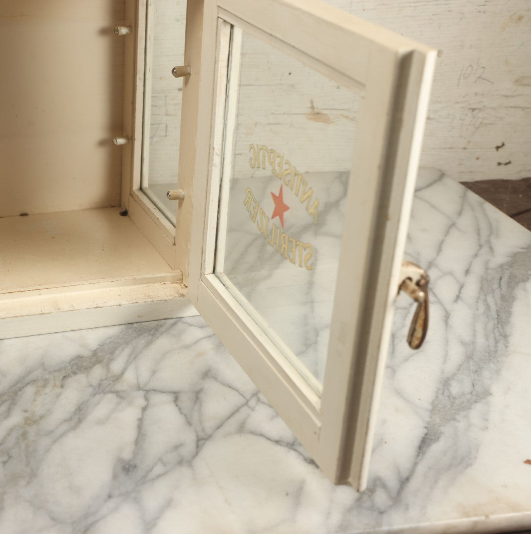Lot 003 - Antique Wooden Barber Shop Antiseptic Sterilizer Cabinet With Glass Sides, Two Glass Shelves, And White Paint, Some Chipping To Shelves, Overall Dimensions Of Cabinet 13"L x 8-1/2"W x 12"H