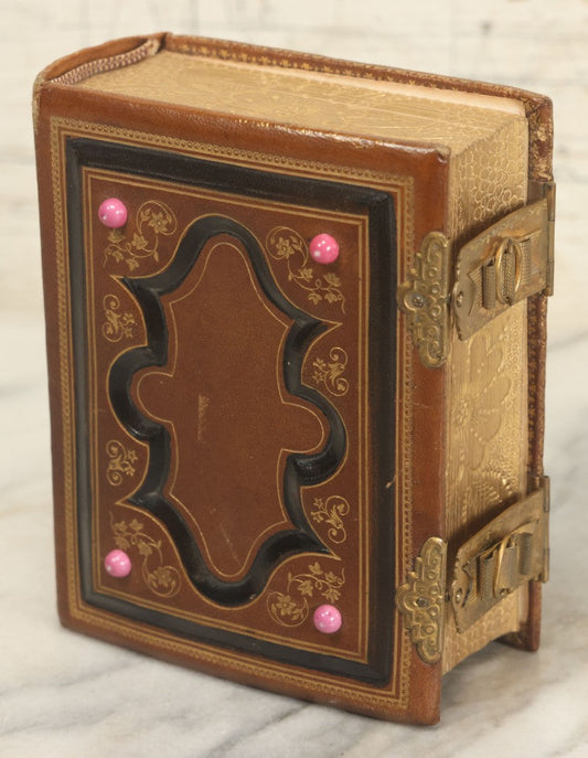 Lot 016 - Antique Victorian Family Photo Album With Pink Painted Milk Glass Decorations And Debossed Fore-Edge Decoration, Containing 9 Tintypes, 18 Carte De Visite C.D.V. Photographs, And 7 C.D.V. Illustrated Album Filler Cards