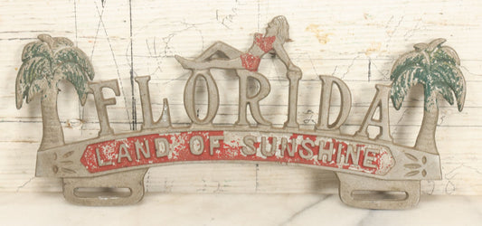 Lot 036 - Vintage Cast Aluminum Florida "Land Of Sunshine" License Plate Topper With Beach Babe In Bikini, Remnants Of Red And Green Paint