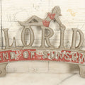 Lot 036 - Vintage Cast Aluminum Florida "Land Of Sunshine" License Plate Topper With Beach Babe In Bikini, Remnants Of Red And Green Paint