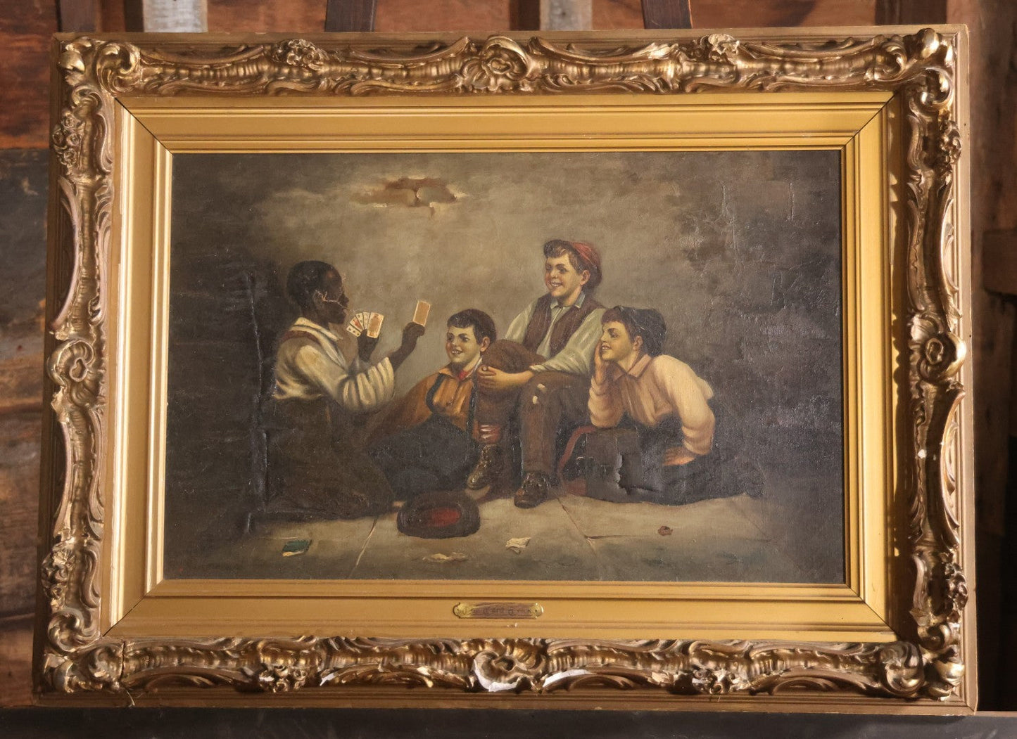 Antique Oil On Canvas Painting Titled "The Card Trick" After John George Brown, Little Boy Showing Off Card Trick To Young Friends, Artist Signed Lower Right, Illegible, In Ornate Frame With Title Plaque, Note Holes, Damage, 37-1/2" x 27-1/2"