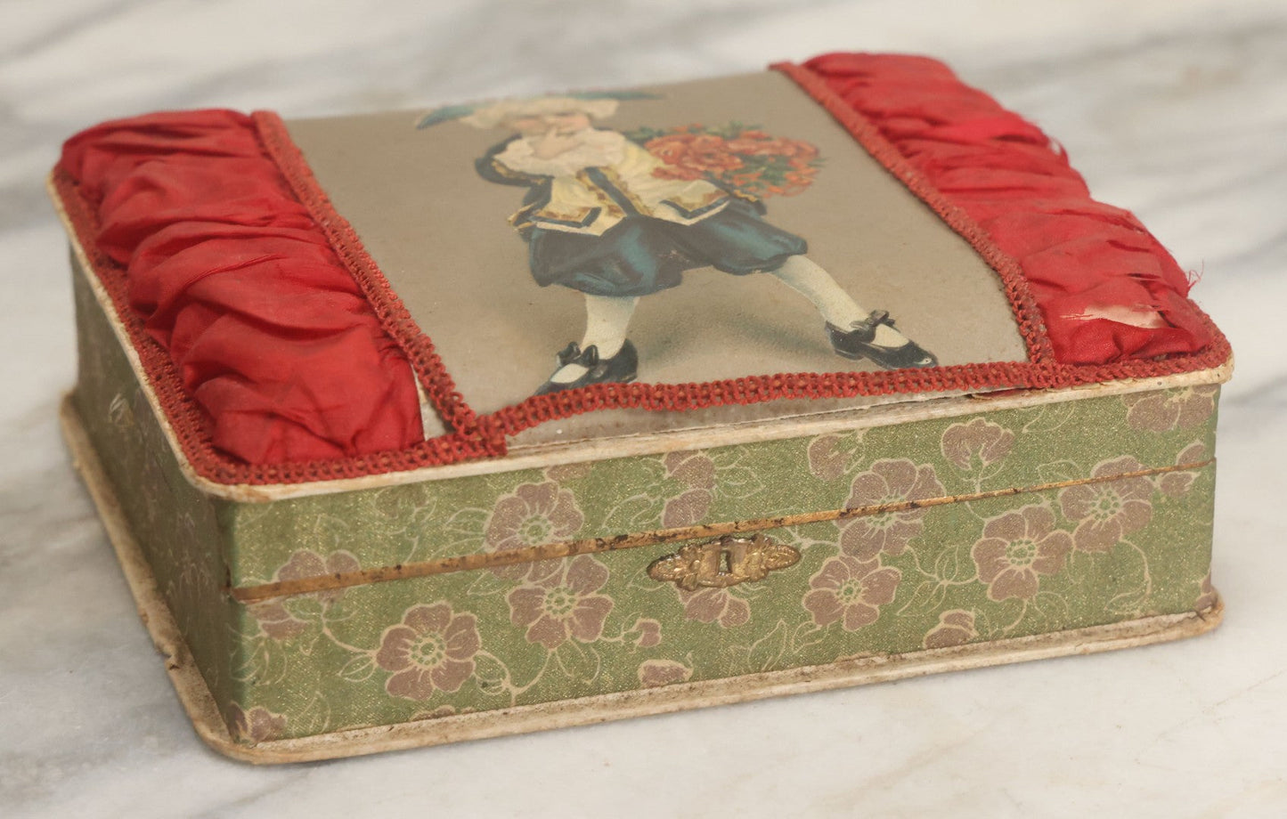 Lot 085 - Antique Paper Board Candy Box With Tufted Red Fabric, Blue Boy With Flowers Graphic On Cover