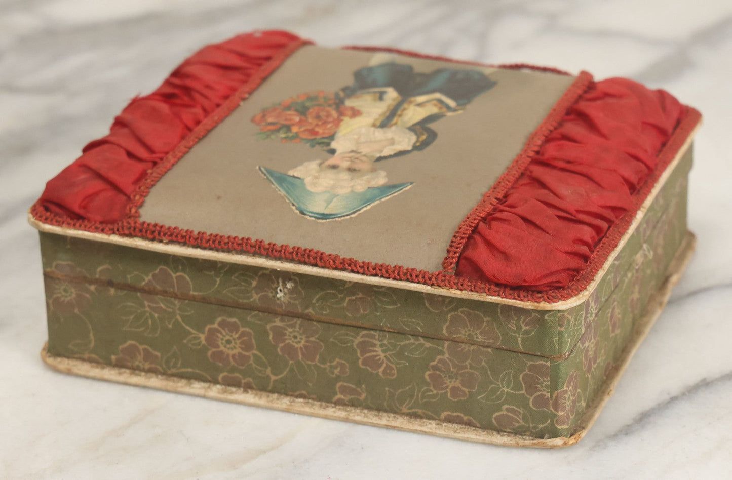 Lot 085 - Antique Paper Board Candy Box With Tufted Red Fabric, Blue Boy With Flowers Graphic On Cover