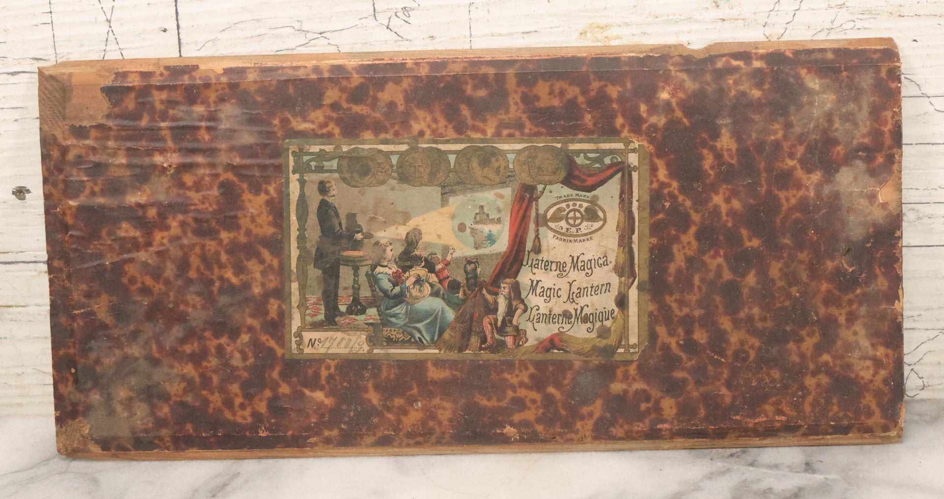 Lot 005 - Antique Magic Lantern Projector In Original Box With Eleven Slides, On Base With Storage Compartment, Original Paper Label Instructions, By Ernst Plank Company, Nuremberg, Germany, Note Missing Metal Chimney