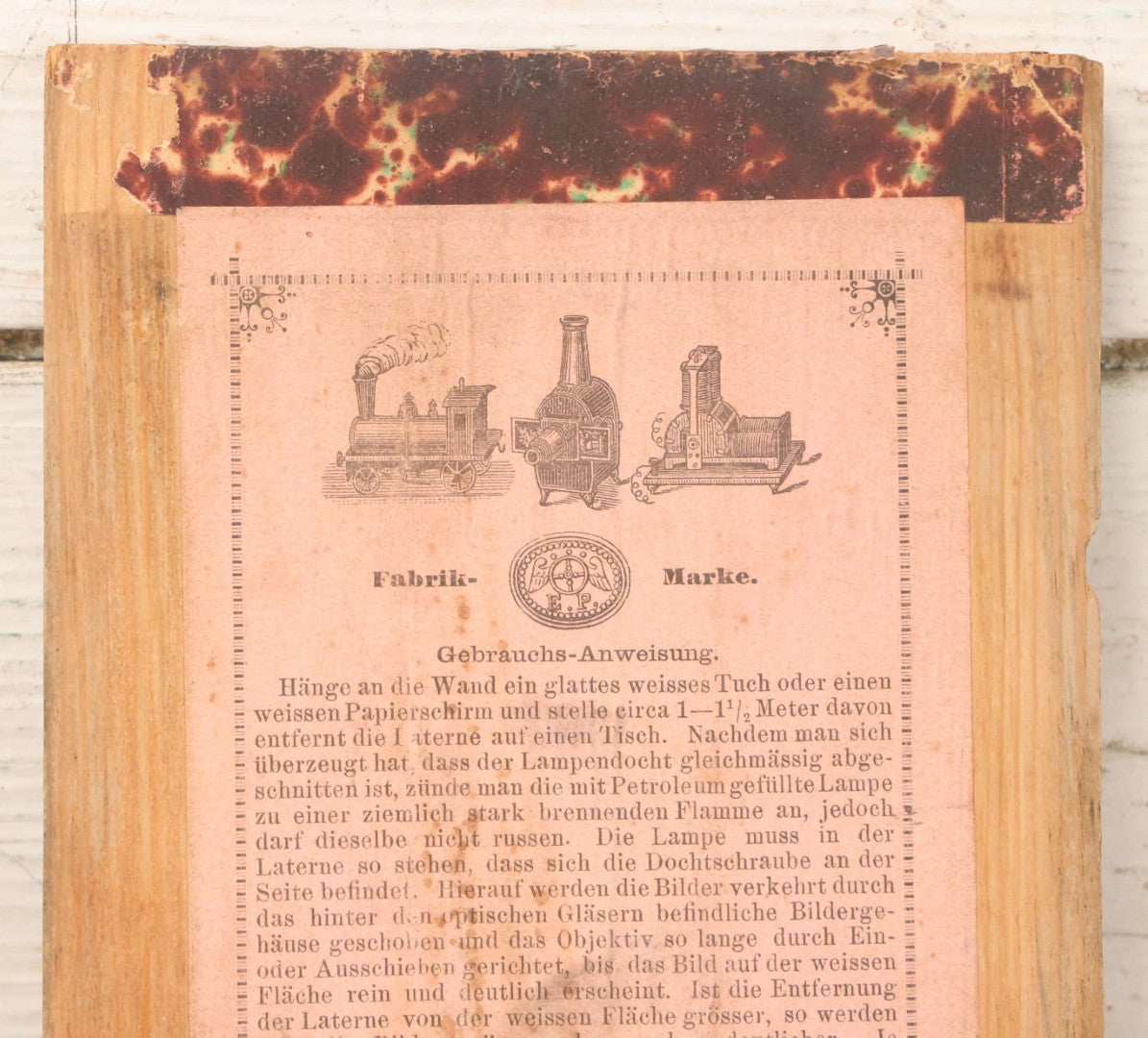 Lot 005 - Antique Magic Lantern Projector In Original Box With Eleven Slides, On Base With Storage Compartment, Original Paper Label Instructions, By Ernst Plank Company, Nuremberg, Germany, Note Missing Metal Chimney