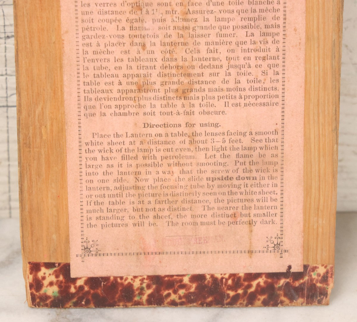 Lot 005 - Antique Magic Lantern Projector In Original Box With Eleven Slides, On Base With Storage Compartment, Original Paper Label Instructions, By Ernst Plank Company, Nuremberg, Germany, Note Missing Metal Chimney