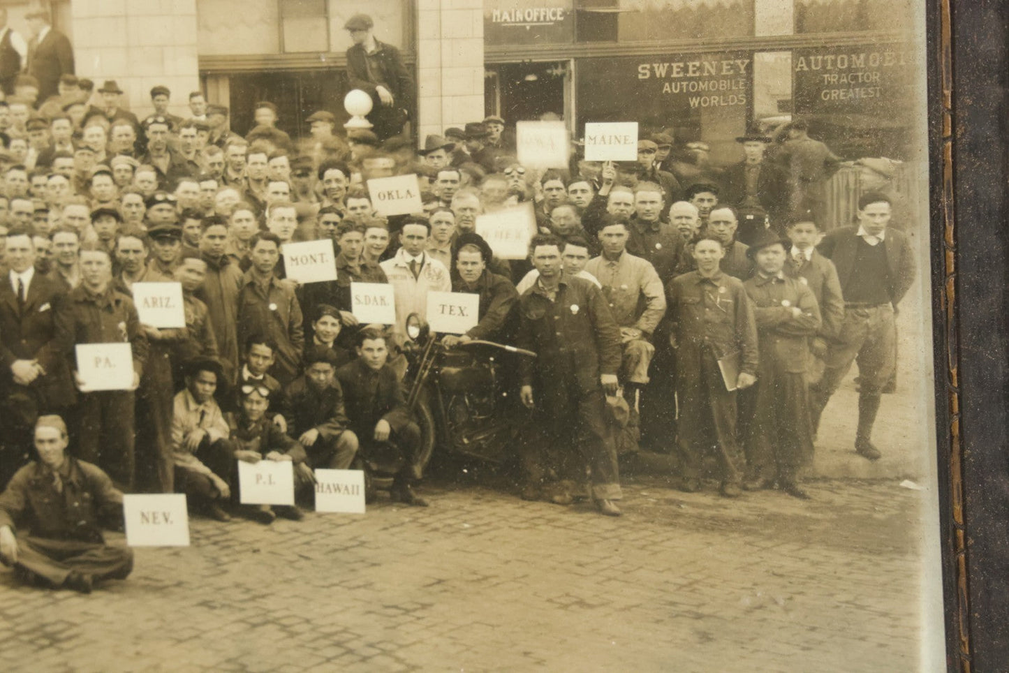 Lot 009 - Antique Framed "Yard-Long" Group Photograph Of The Students Of Sweeney Auto School, April 14th, 1921, Photo Taken By Riederer, Kansas City, Missouri, Note Texas Man On Motorcycle, 21" x 9-1/4"