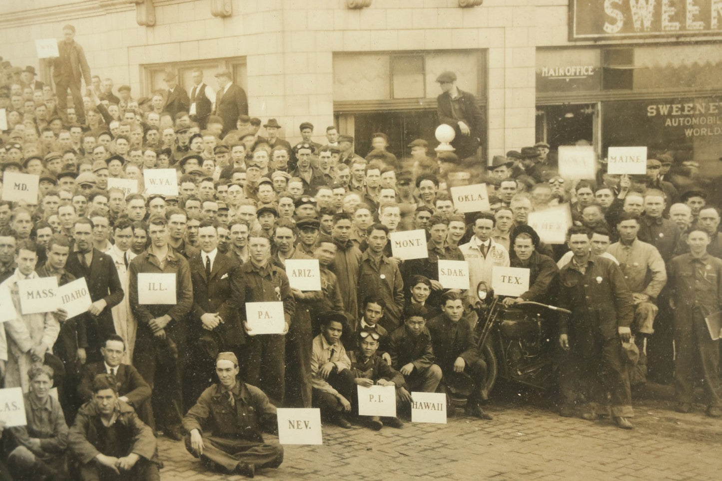 Lot 009 - Antique Framed "Yard-Long" Group Photograph Of The Students Of Sweeney Auto School, April 14th, 1921, Photo Taken By Riederer, Kansas City, Missouri, Note Texas Man On Motorcycle, 21" x 9-1/4"