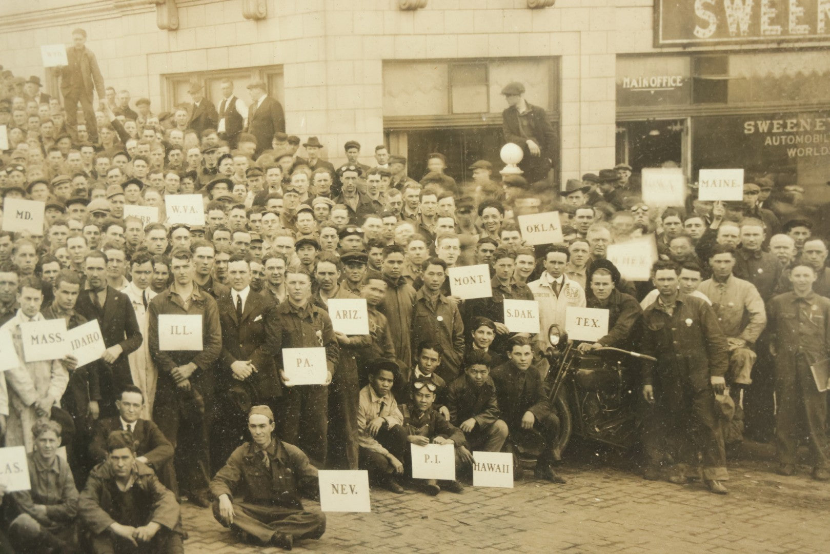 Lot 009 - Antique Framed "Yard-Long" Group Photograph Of The Students Of Sweeney Auto School, April 14th, 1921, Photo Taken By Riederer, Kansas City, Missouri, Note Texas Man On Motorcycle, 21" x 9-1/4"