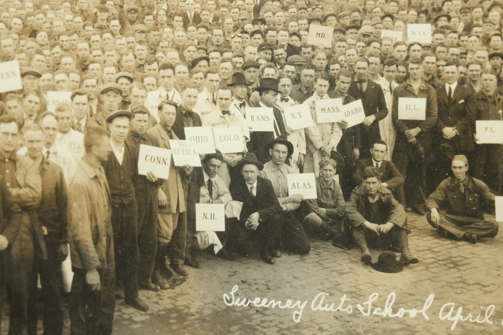 Lot 009 - Antique Framed "Yard-Long" Group Photograph Of The Students Of Sweeney Auto School, April 14th, 1921, Photo Taken By Riederer, Kansas City, Missouri, Note Texas Man On Motorcycle, 21" x 9-1/4"