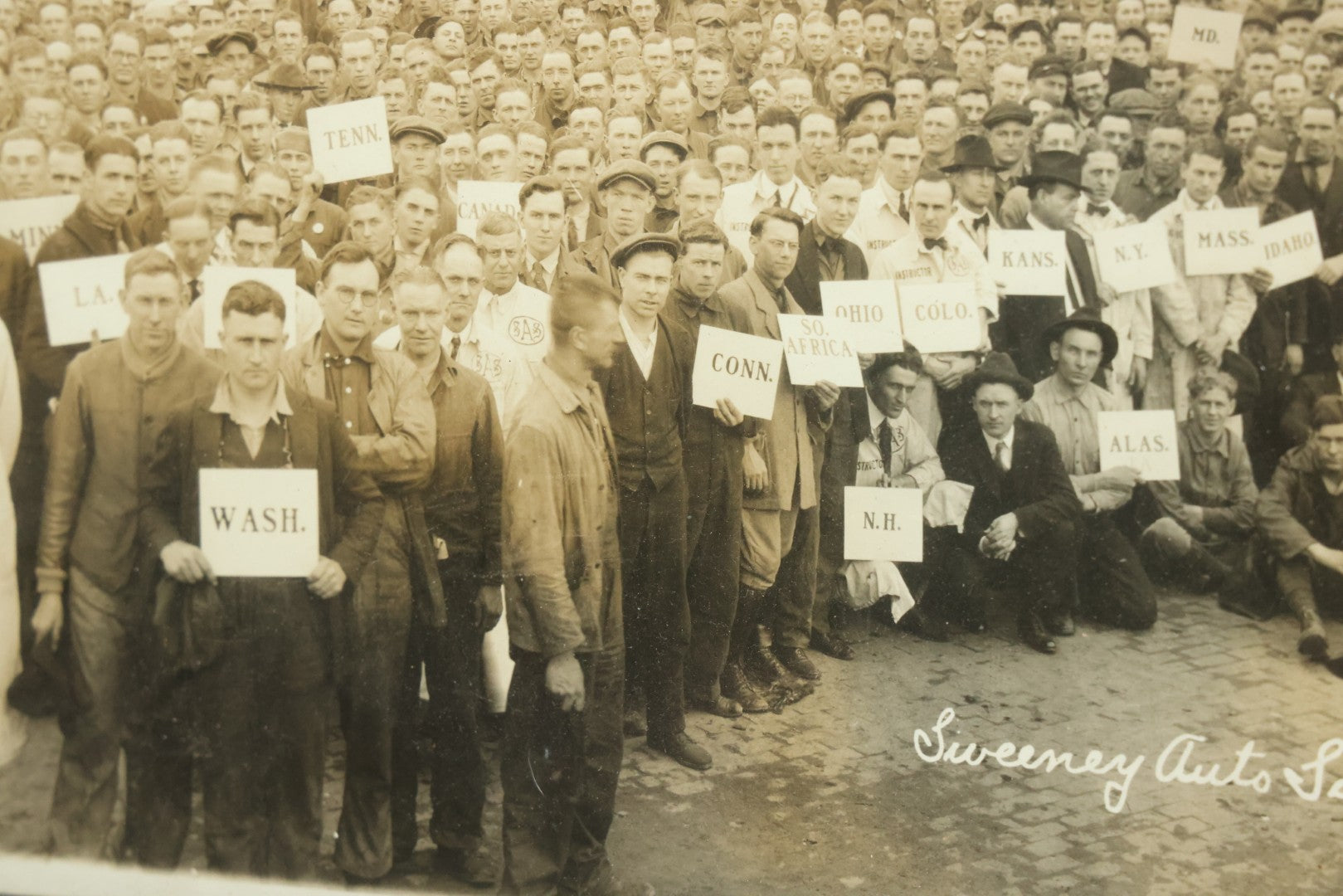 Lot 009 - Antique Framed "Yard-Long" Group Photograph Of The Students Of Sweeney Auto School, April 14th, 1921, Photo Taken By Riederer, Kansas City, Missouri, Note Texas Man On Motorcycle, 21" x 9-1/4"