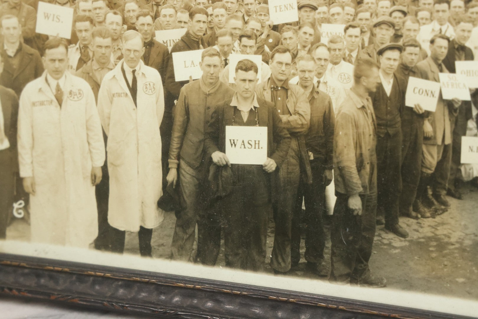Lot 009 - Antique Framed "Yard-Long" Group Photograph Of The Students Of Sweeney Auto School, April 14th, 1921, Photo Taken By Riederer, Kansas City, Missouri, Note Texas Man On Motorcycle, 21" x 9-1/4"