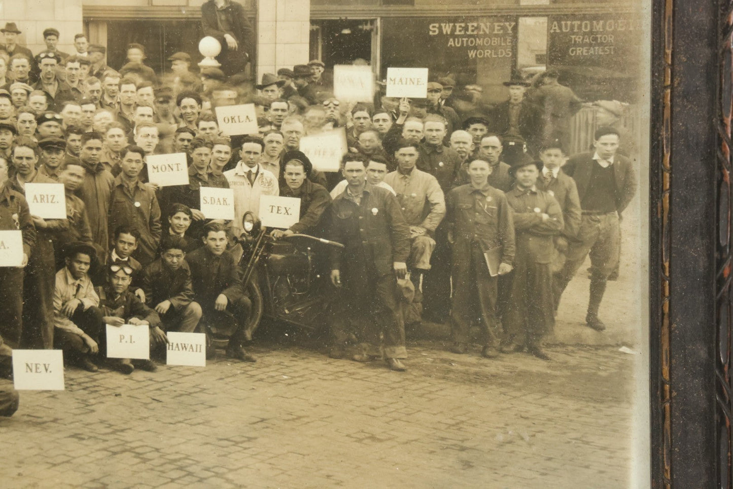 Lot 009 - Antique Framed "Yard-Long" Group Photograph Of The Students Of Sweeney Auto School, April 14th, 1921, Photo Taken By Riederer, Kansas City, Missouri, Note Texas Man On Motorcycle, 21" x 9-1/4"