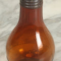 Lot 067 - Antique Amber Glass Light Bulb Shaped Perfume Bottle With Metal Shaker Lid, Marked Mary Garden Rigaud, Paris & New York, Patented January 13, 1914